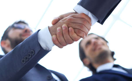 Cropped image of business people shaking hands in creative office