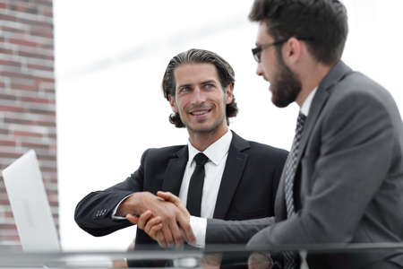 confident handshake colleagues in the officeの写真素材