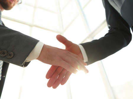 Two  business men going to make handshakeの写真素材