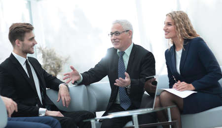 senior businessman and business team sitting in office.の写真素材