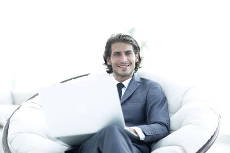 Close-up portrait of a successful business man with a laptop.の写真素材