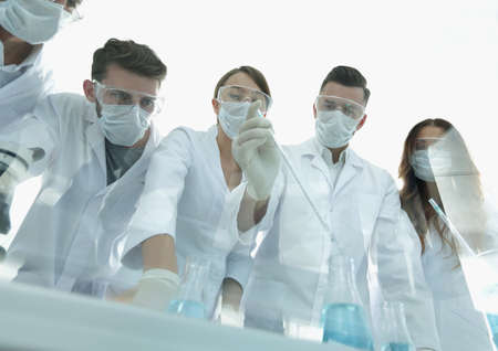 scientists working with test tubes and microscope in the laboratoryの写真素材