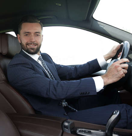 portrait of confident businessman driving a car