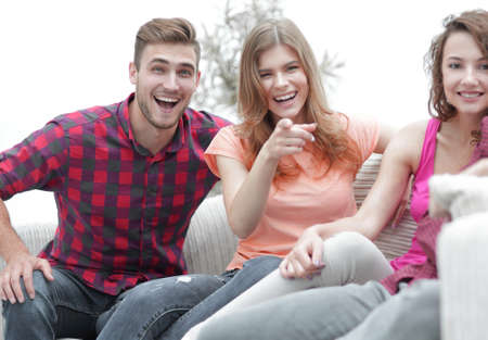 group of happy young people sitting on the couch