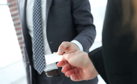 Close-up of two businesspeople exchanging visiting card
