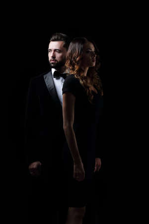 photo of young family couple on black background.の写真素材