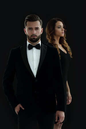 gentleman with his girl posing in the studioの写真素材