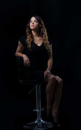 Studio shoot of beauty woman posing on the chairの写真素材