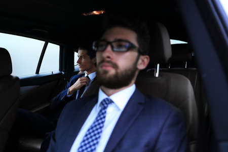 business people sitting in car