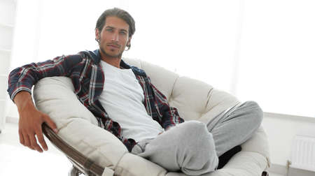 successful guy resting in modern living room.の写真素材