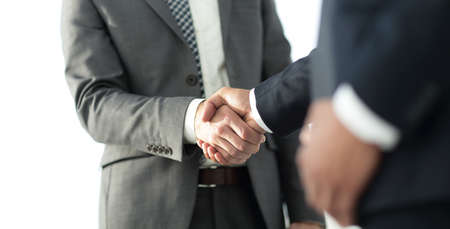 Friendly smiling businessmen handshaking. Business concept photoの写真素材