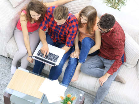 group of friends with a laptop,discussing the videoの写真素材