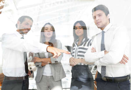 from behind the glass.successful business teamの写真素材