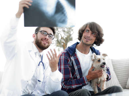 veterinarian showing an x-ray to the owner of the dog.の写真素材