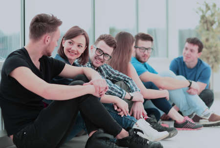 beautiful girl University student with friends sitting on the flの写真素材