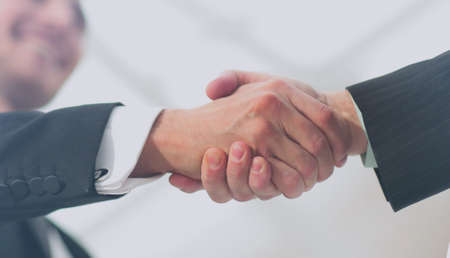 Portrait of a young handsome businessman making handshakeの写真素材