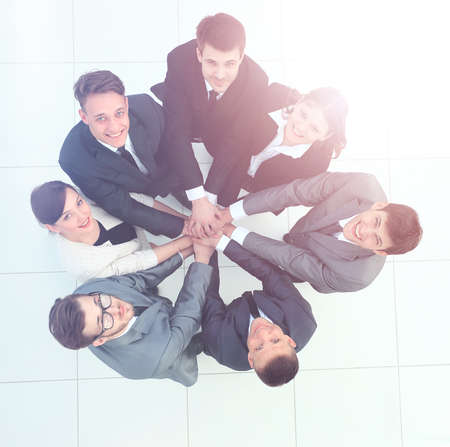 Top view of business people with their hands together in a circle