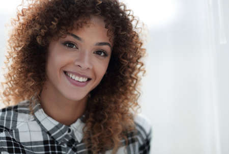 Portrait of a beautiful young woman with curly hair.の写真素材
