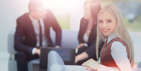 Portrait of happy businesswoman with two colleagues interacting