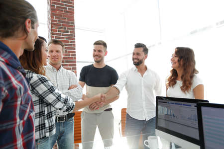 friendly handshake of partners in the office