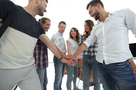 .friendly team of designers clasped their hands together