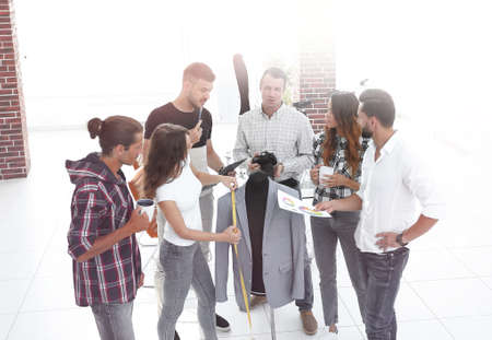 group of designers discussing new models of mens clothing.