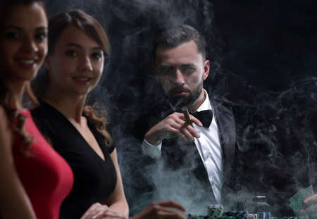 Upper class friends gambling in a casino.の写真素材