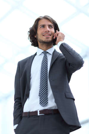 businessman talking on mobile .isolated on white.の写真素材