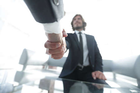Close-up of two business people shaking handsの写真素材