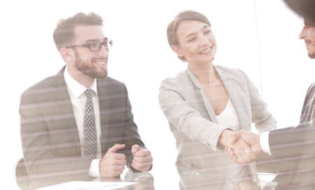 from behind the glass.handshake business people