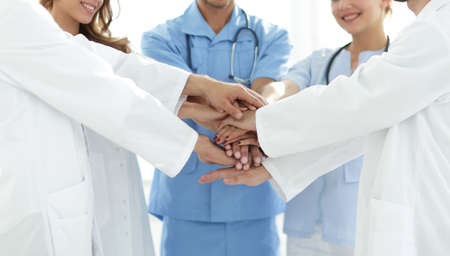 Doctors and nurses stacking hands. concept of mutual aid.の写真素材