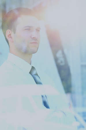 business man looking through windowの写真素材