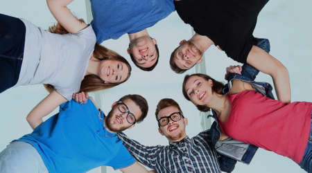 Low angle view of happy men and women standing together in a circleの写真素材