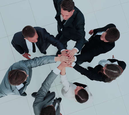 Top view of business people with their hands together in a circle