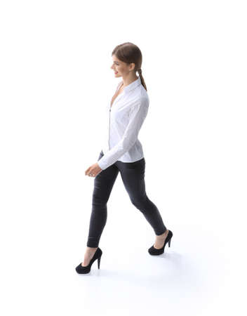 In full growth. The modern young woman confidently goes forward.の写真素材