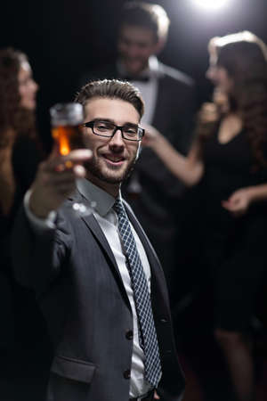 elegant man raising a glass of champagneの写真素材