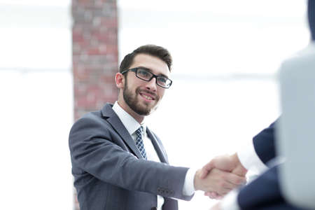 Two business colleagues shaking hands during meeting.の写真素材