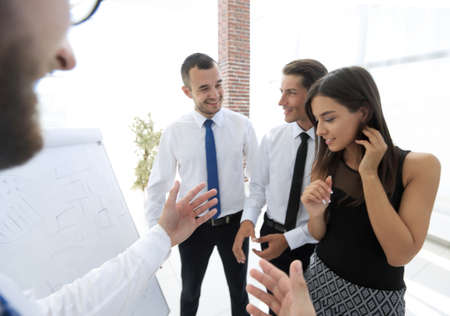 businessman pointing business team on a blank flipchart.の写真素材