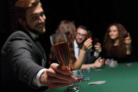 poker player with a glass of wineの写真素材