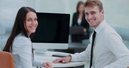 Image of two young business people interacting at meeting in off