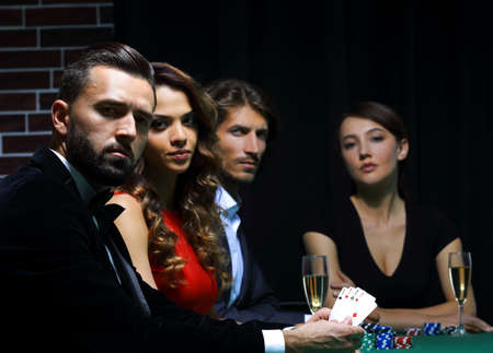 side view of group of people playing poker together in casino