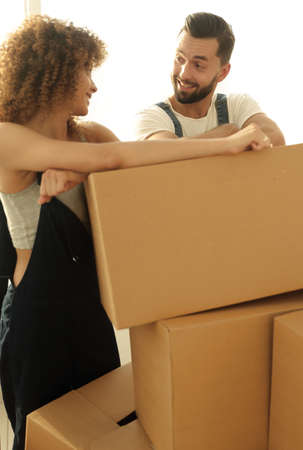 Happy couple honeymooners standing near boxes