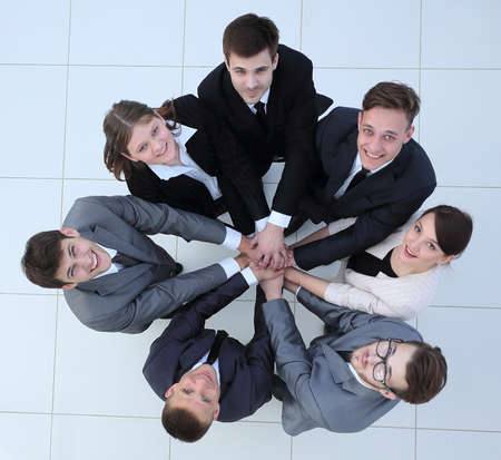 view from the top.business team holding hands and looking up.の写真素材