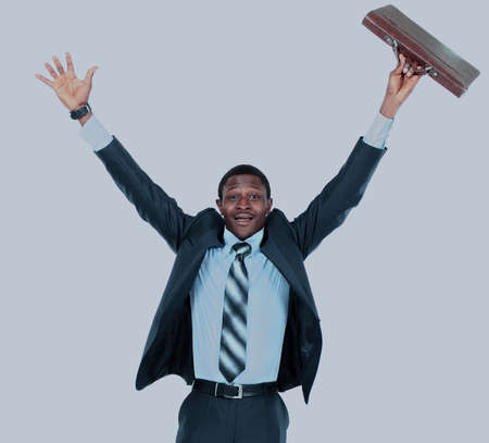 Full length of an excited handsome business man with arms raised in success - Isolated on whiteの写真素材