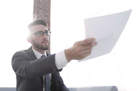 Image of business man holding paperの写真素材