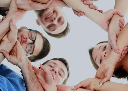 friendship, youth and people concept - group of smiling teenagers with hands on top of each otherの写真素材