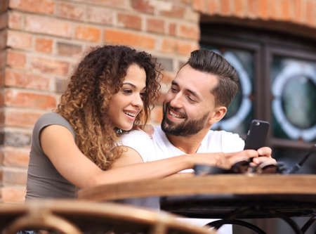 Beautiful couple having coffee on a date,having fun together.の写真素材