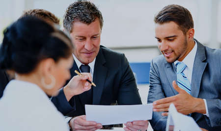 business partners discussing documents and ideas at meeting