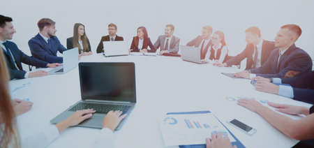 business partners gathered round the table and prepared to discu