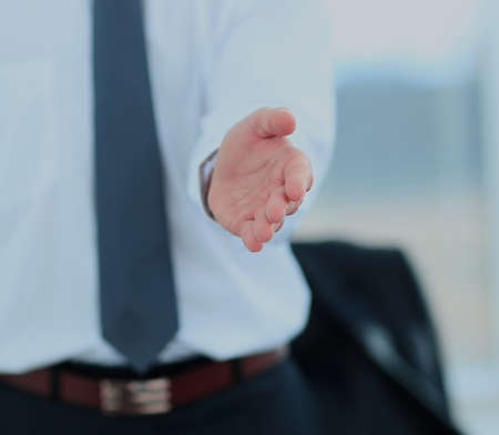 A business man with an open hand ready to seal a deal